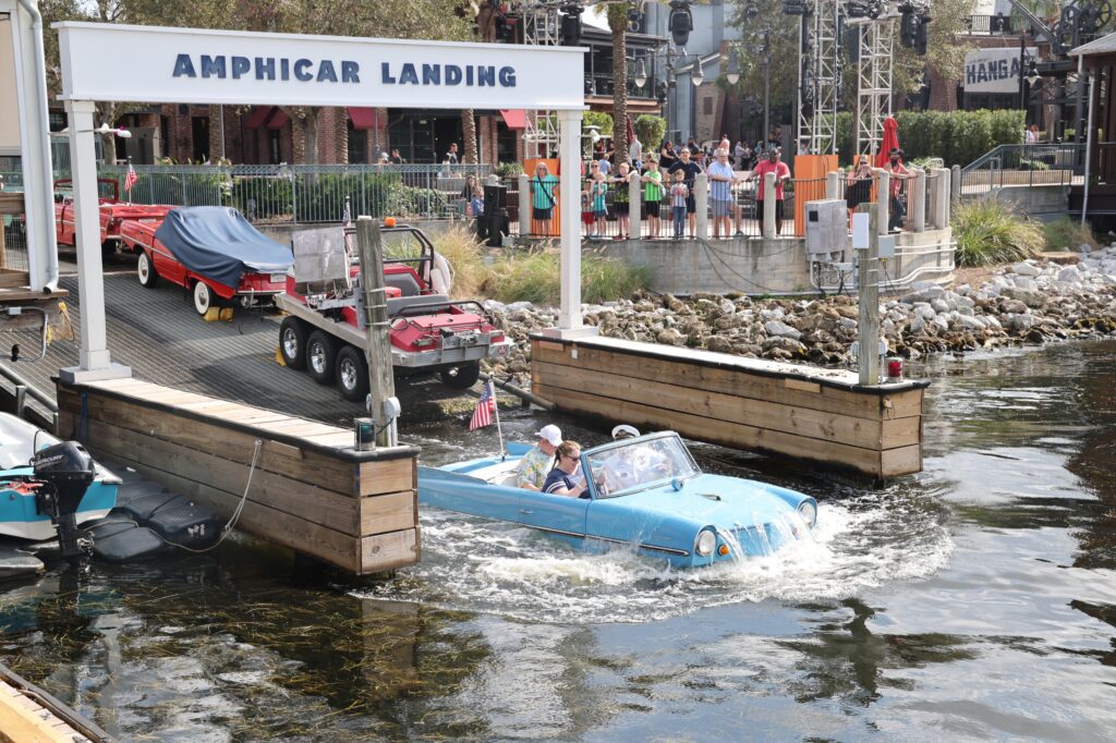 blue amphicar going into the water from the dock at Disney Springs